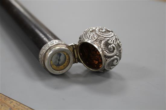 A Victorian walking stick with embossed silver pommel H.M., Birmingham 1906, opens to reveal a compass, overall length 89.5cm